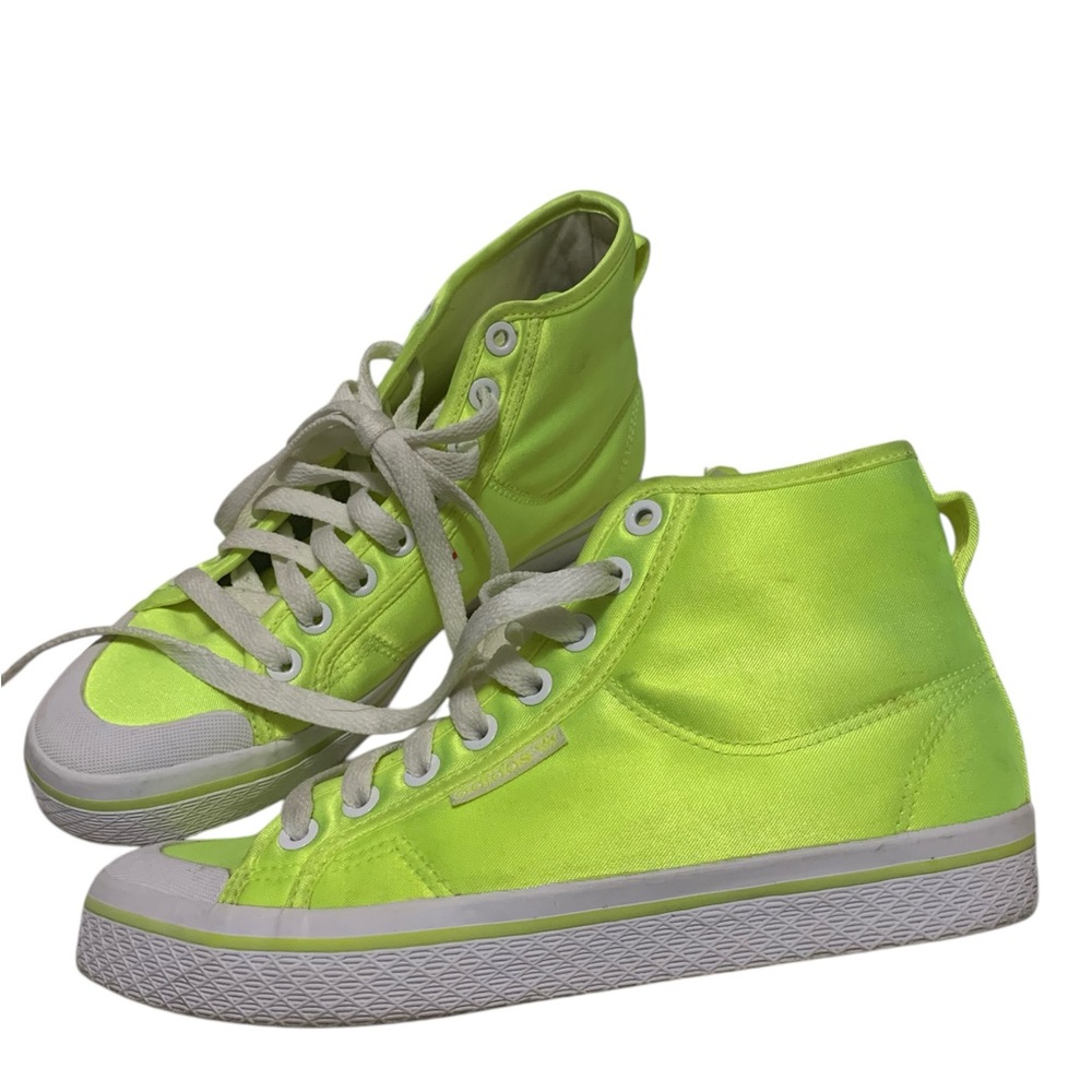 Fluorescent yellow adidas shoes.